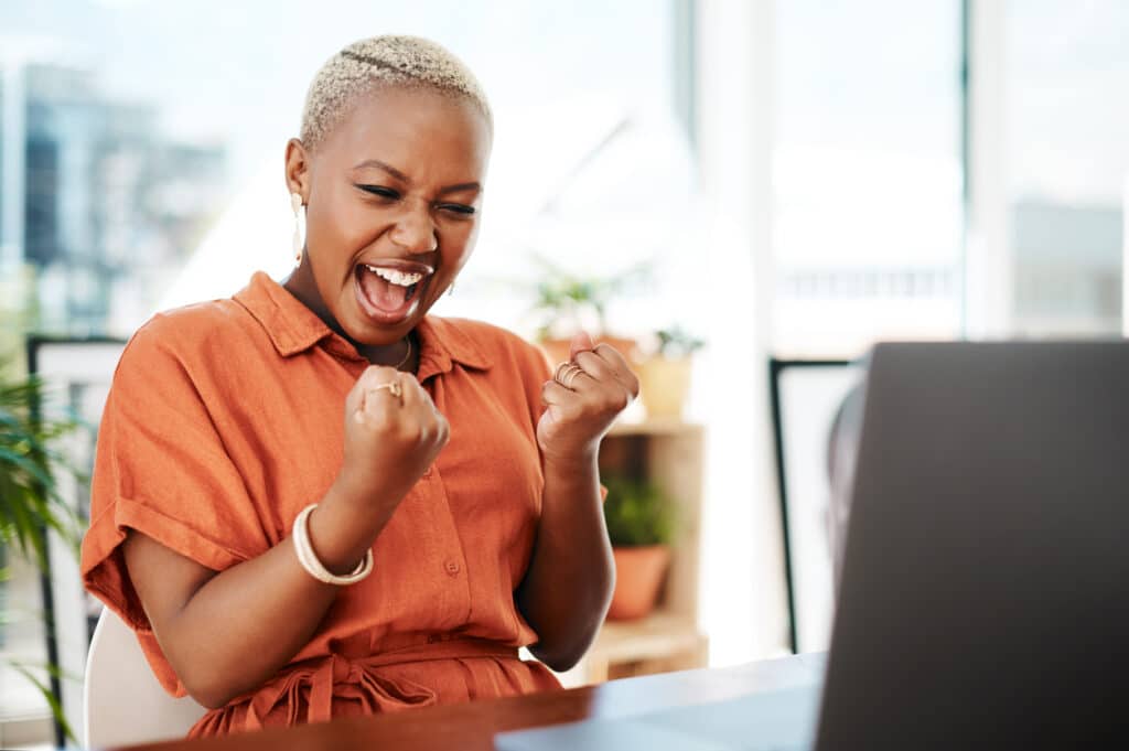 Woman cheering after winning an online game