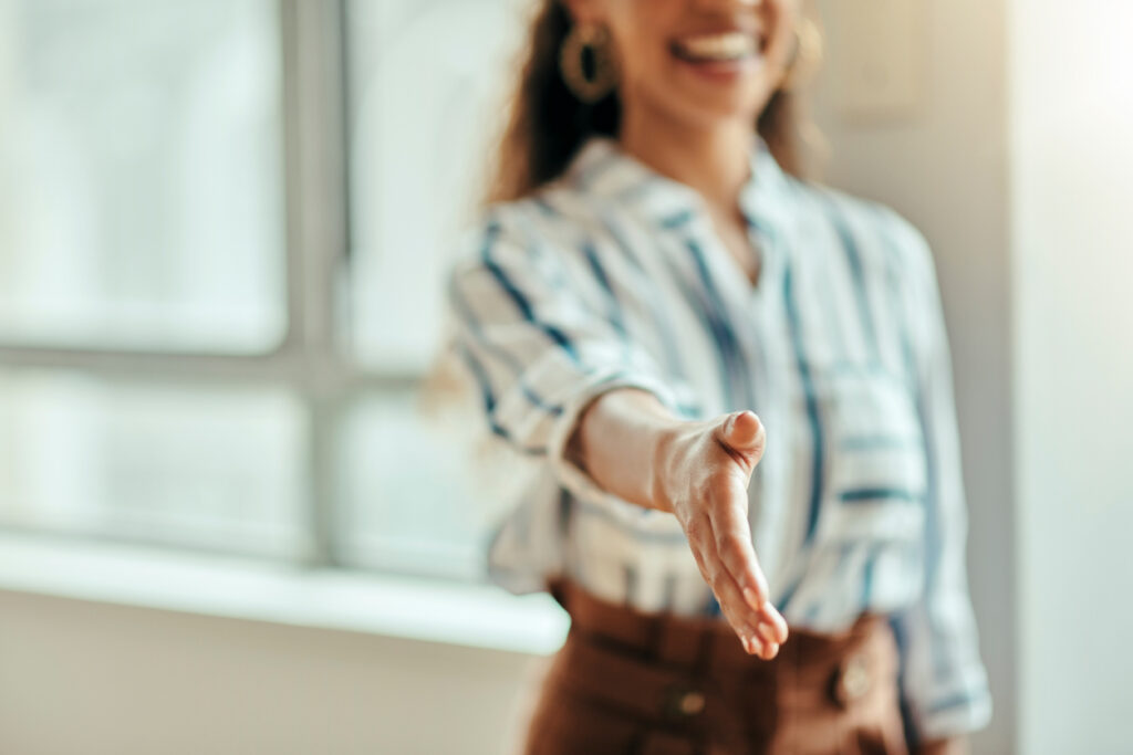 Woman offering handshake to new member