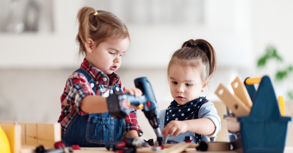 Two kids work on pretend carpentry - blog