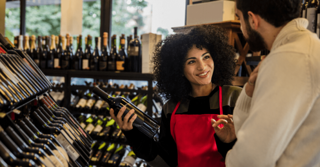 Wine merchant selling wine to a repeat customer